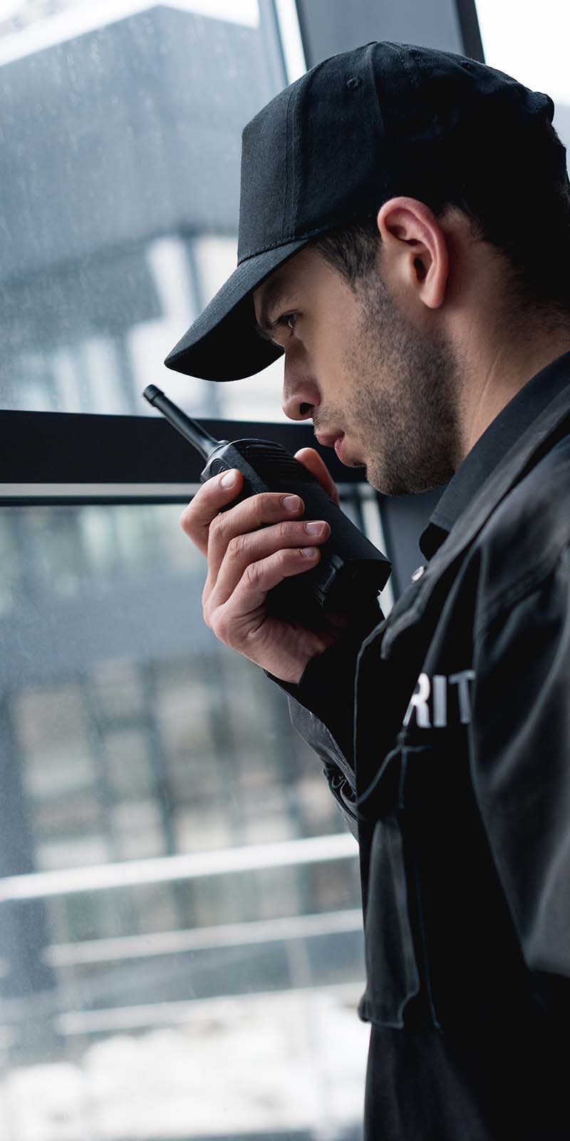 handsome-guard-in-black-uniform-talking-on-walkie-GDJCVQ4.jpg